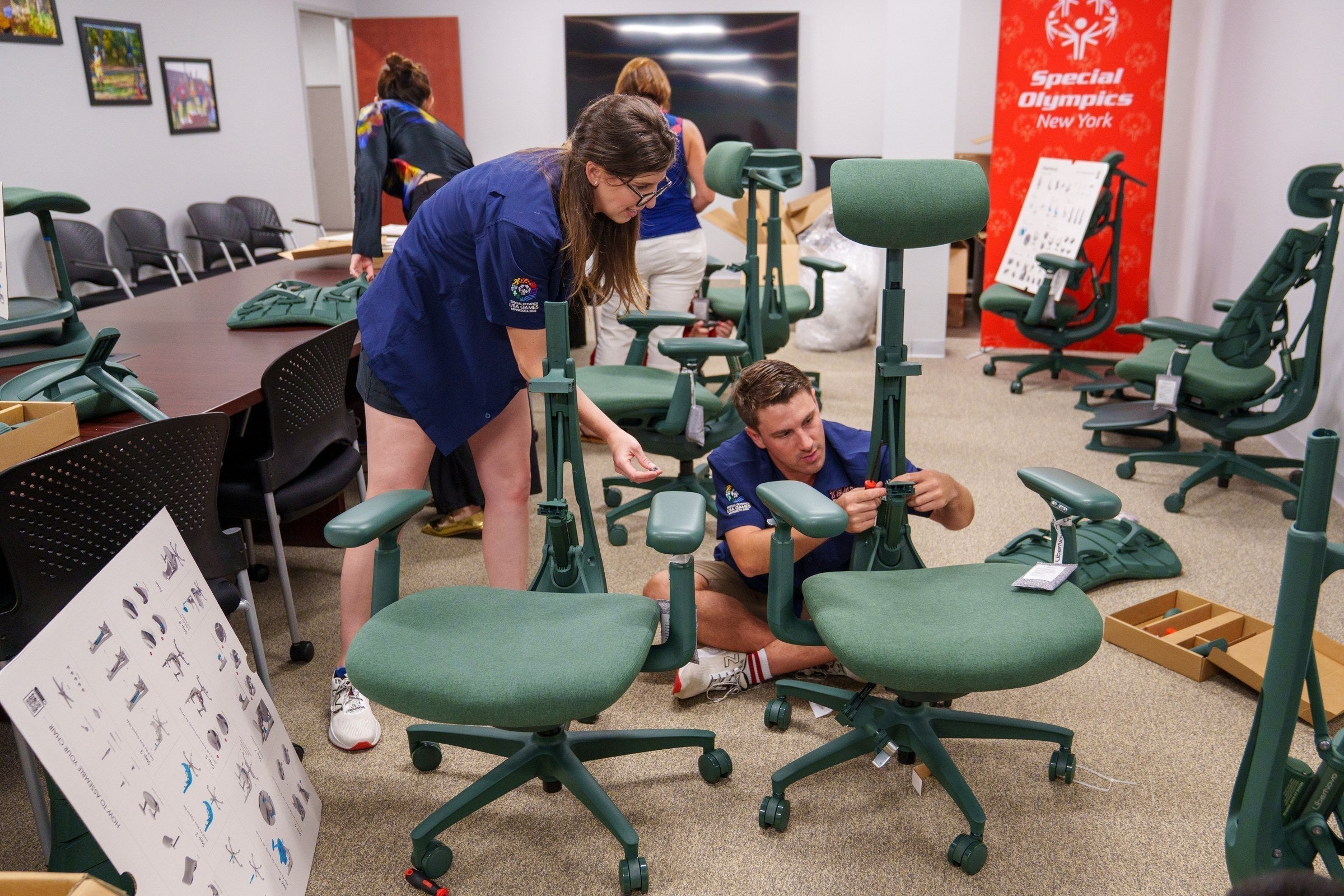 Special Olympics New York staff with donated LiberNovo Omni chairs